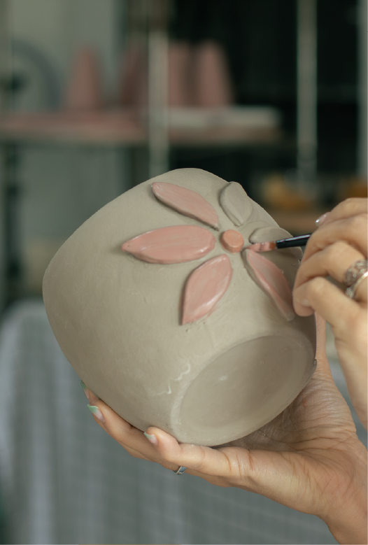 Pieza de cer&aacute;mica decorada con guardas y texturas en relieve sobre el torno de mesa